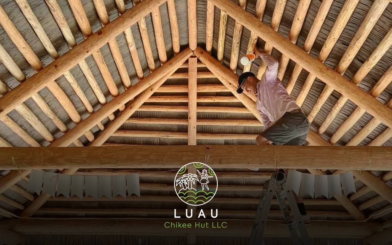 Technicians maintaining thatch roofs after fire-retardant thatch certification Florida approval